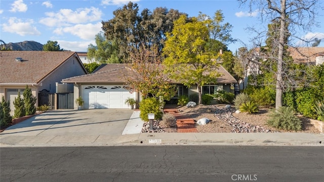 view of front of house with a garage and a mountain view