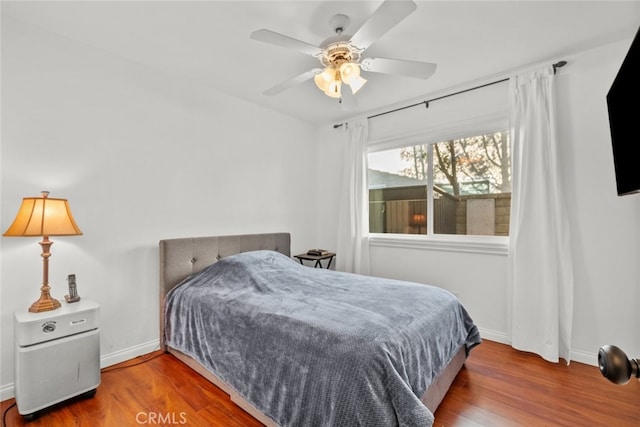 bedroom featuring hardwood / wood-style flooring and ceiling fan