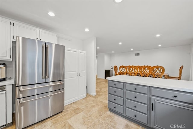 kitchen featuring white cabinetry, high quality fridge, and gray cabinetry