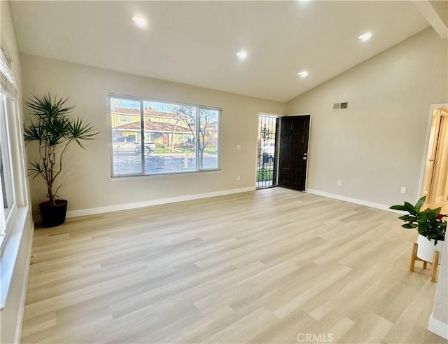 interior space featuring high vaulted ceiling and light hardwood / wood-style flooring