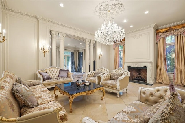 living area with light tile patterned floors, decorative columns, ornamental molding, and a healthy amount of sunlight