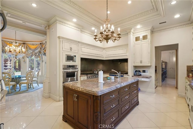 kitchen with a notable chandelier, light stone countertops, appliances with stainless steel finishes, and light tile patterned floors