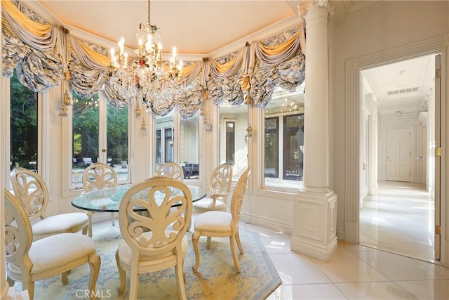 dining area featuring light tile patterned flooring, decorative columns, visible vents, a notable chandelier, and crown molding