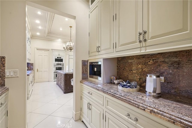 kitchen featuring recessed lighting, light stone counters, light tile patterned floors, crown molding, and tasteful backsplash