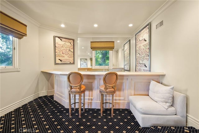 bar featuring baseboards, visible vents, recessed lighting, crown molding, and carpet floors