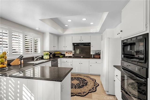 kitchen featuring sink, black appliances, kitchen peninsula, white cabinets, and a raised ceiling