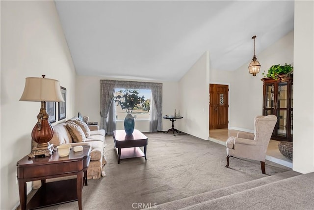 living room featuring high vaulted ceiling and carpet