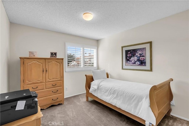 carpeted bedroom with a textured ceiling