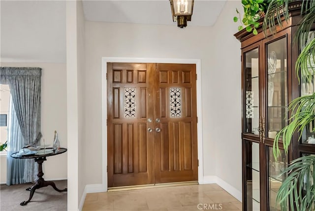 foyer entrance with light tile patterned floors