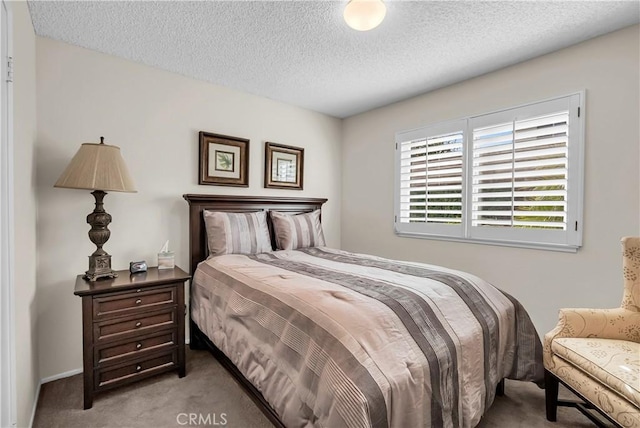 carpeted bedroom featuring a textured ceiling