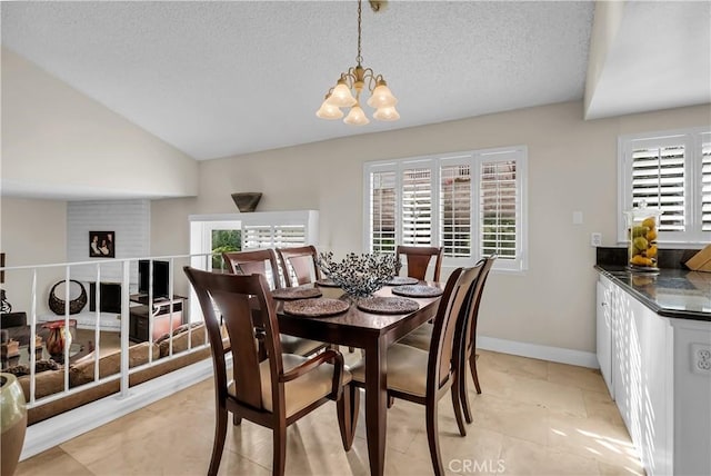 dining area with an inviting chandelier, vaulted ceiling, and a textured ceiling