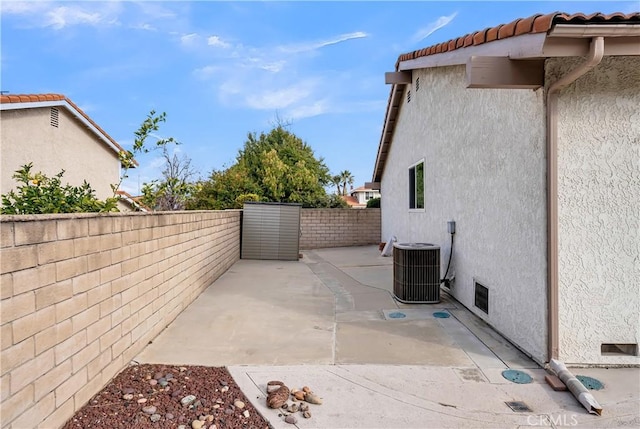 view of home's exterior with central AC and a patio