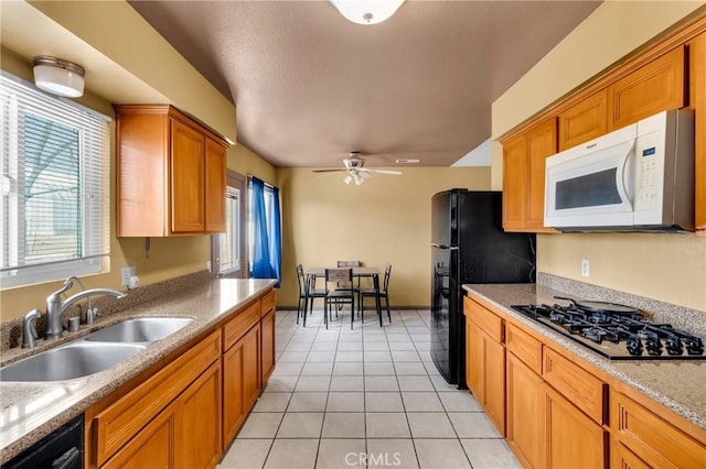 kitchen featuring ceiling fan, light tile patterned floors, sink, and black appliances