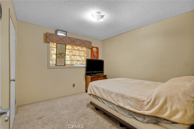 carpeted bedroom featuring a textured ceiling