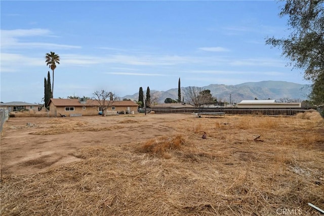 view of yard with a rural view and a mountain view