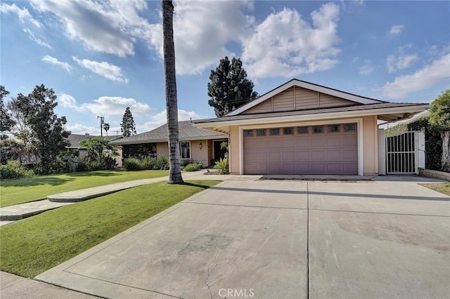 ranch-style house featuring a garage and a front yard