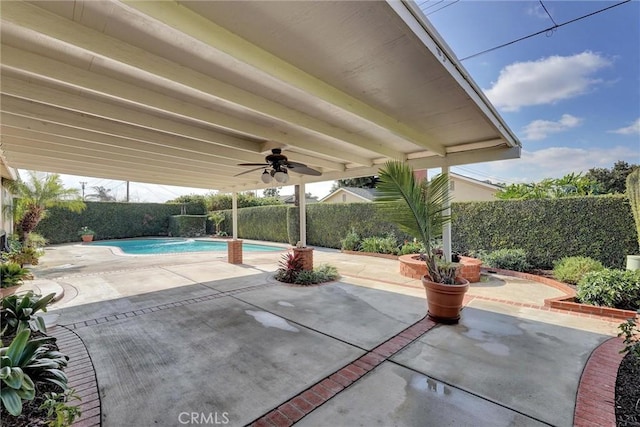 view of patio with a fenced in pool and ceiling fan