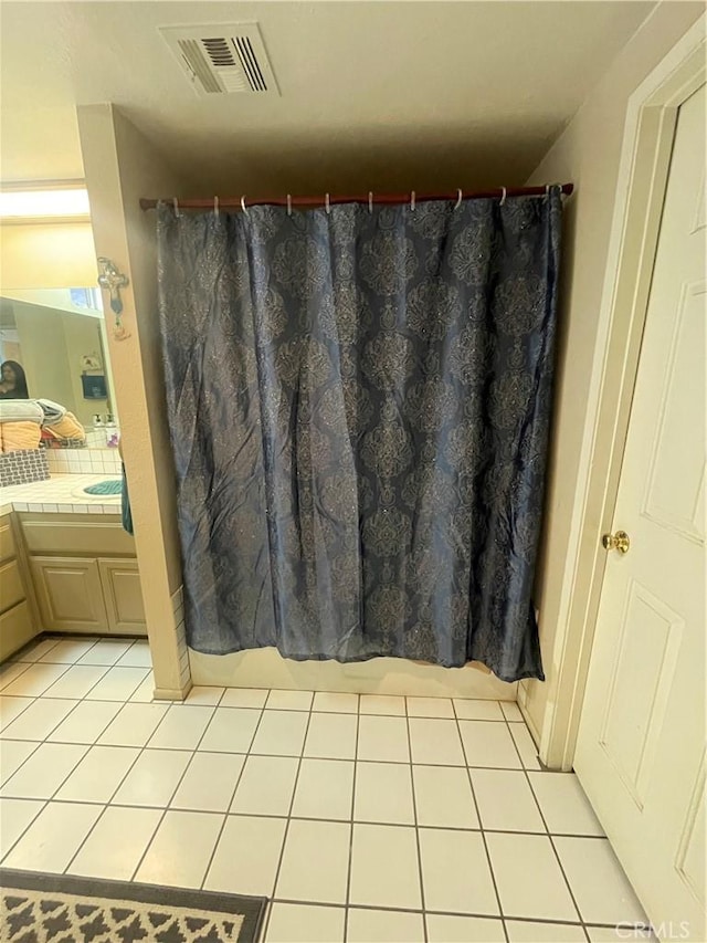 bathroom with vanity, a shower with curtain, and tile patterned floors