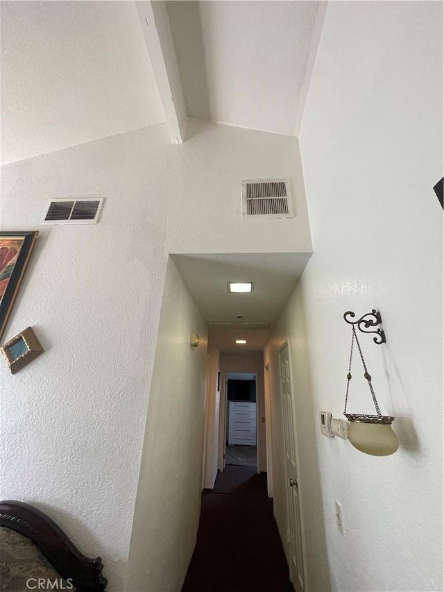 hallway featuring lofted ceiling with beams