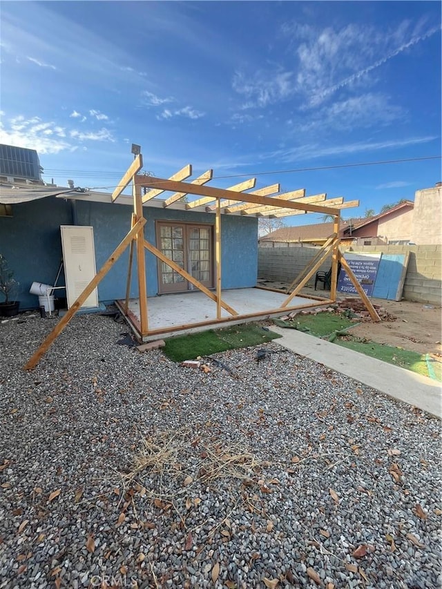 view of yard featuring a patio area and french doors