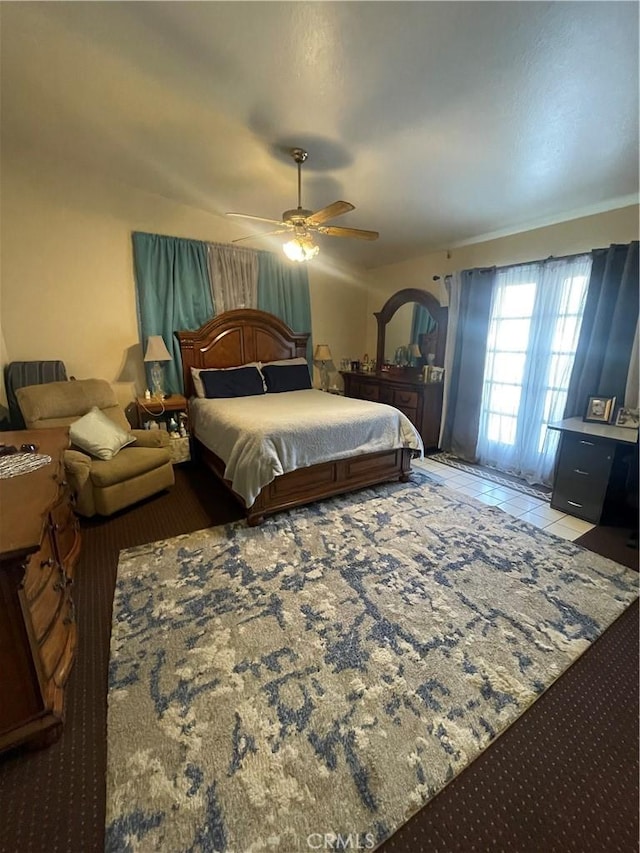 bedroom with ceiling fan and tile patterned floors