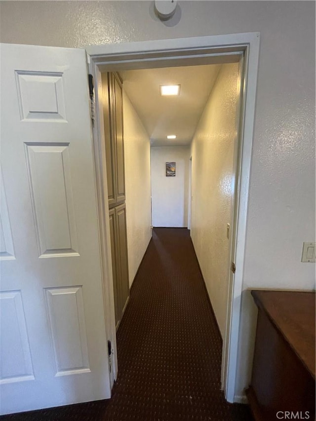 hallway with dark carpet