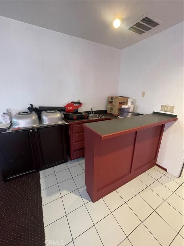 office space featuring light tile patterned flooring and sink