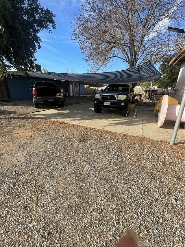 view of vehicle parking with a carport