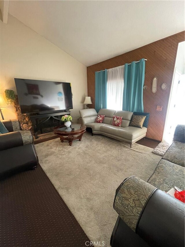 carpeted living room with lofted ceiling