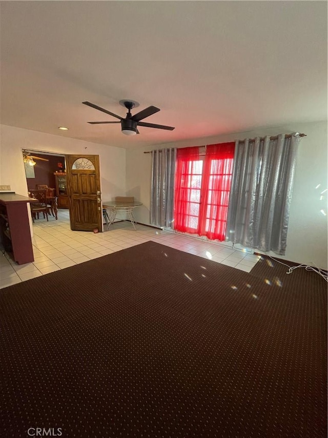 interior space with ceiling fan and light tile patterned flooring