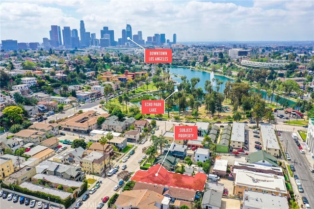 drone / aerial view featuring a water view and a view of city