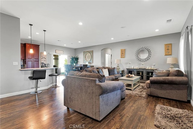 living room with dark hardwood / wood-style flooring