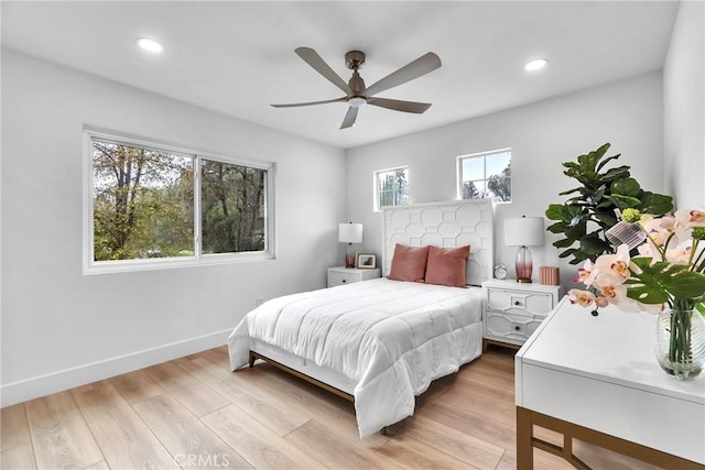 bedroom with ceiling fan and light hardwood / wood-style floors