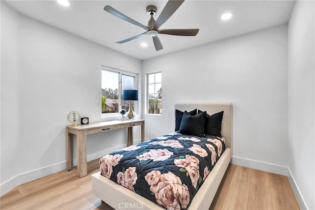 bedroom with ceiling fan and light hardwood / wood-style flooring