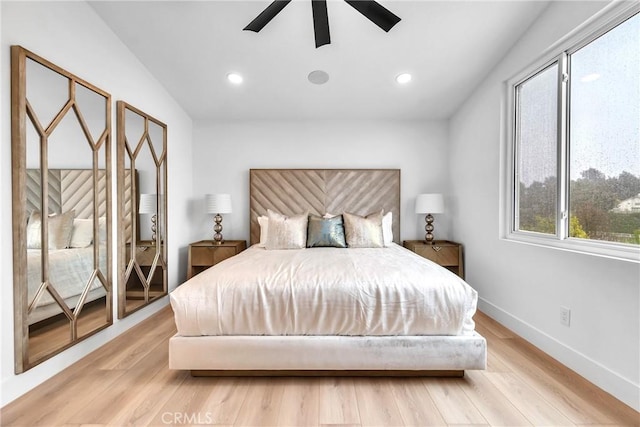 bedroom with ceiling fan and light hardwood / wood-style floors