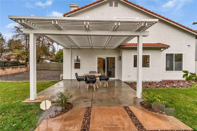 back of property with a yard, a pergola, and a patio area