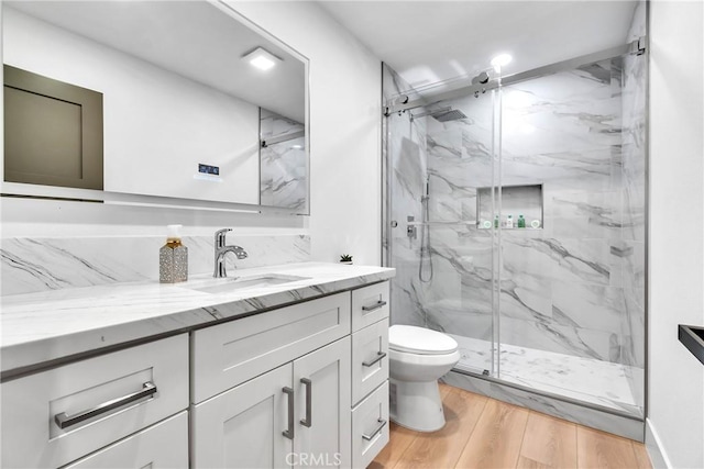 bathroom featuring vanity, hardwood / wood-style floors, toilet, and an enclosed shower