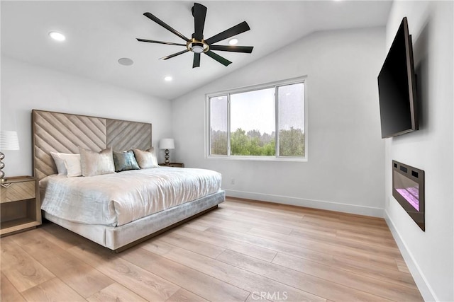 bedroom featuring vaulted ceiling, ceiling fan, and light hardwood / wood-style flooring