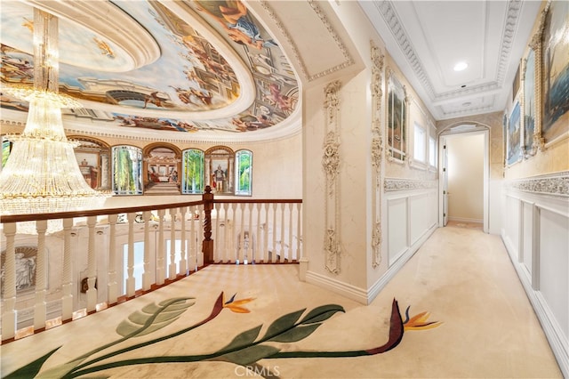 corridor featuring light carpet, a tray ceiling, and ornamental molding