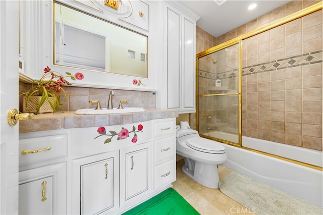 full bathroom featuring enclosed tub / shower combo, vanity, and toilet