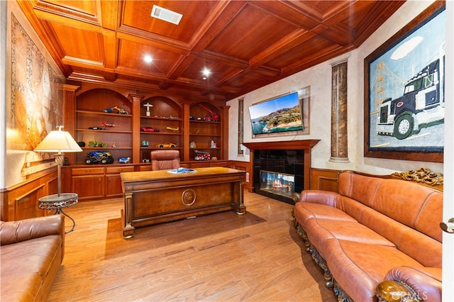 home office with light hardwood / wood-style flooring, coffered ceiling, a fireplace, built in shelves, and wooden ceiling