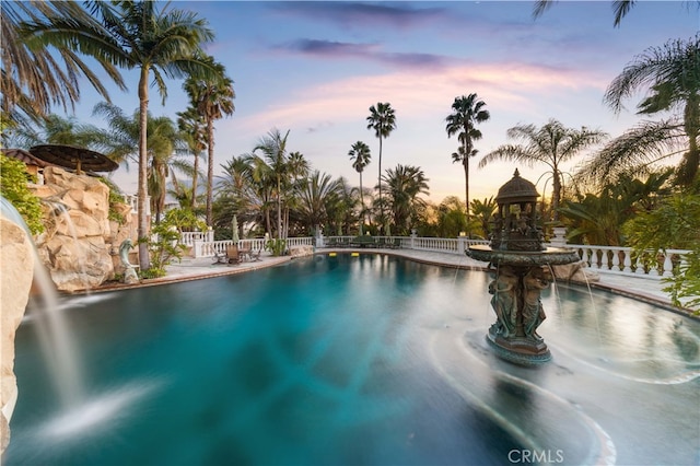 pool at dusk with a gazebo