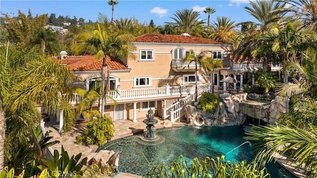 rear view of property featuring a balcony