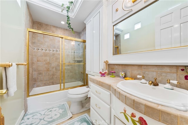 full bathroom with toilet, vanity, and shower / bath combination with glass door