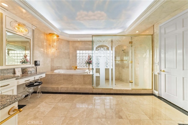 bathroom with a relaxing tiled tub, vanity, and crown molding