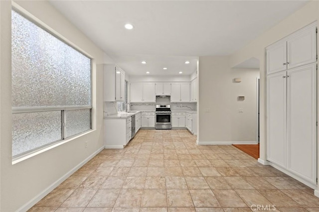 kitchen with white cabinetry, stainless steel appliances, and sink