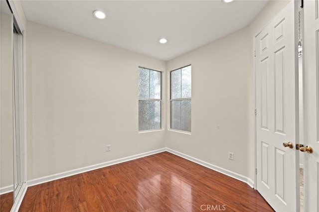 unfurnished bedroom with wood-type flooring and a closet