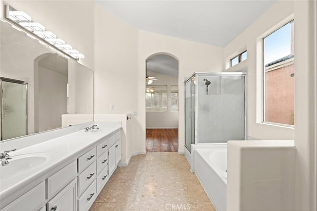 bathroom with vanity, plenty of natural light, ceiling fan, and separate shower and tub