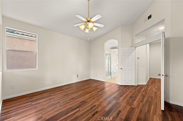 unfurnished room featuring lofted ceiling, dark wood-type flooring, and ceiling fan