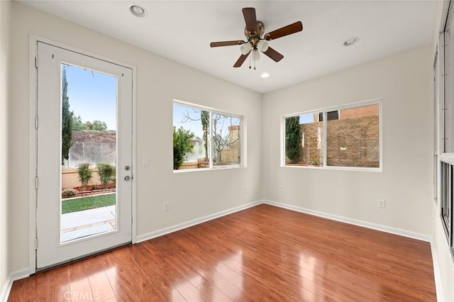 interior space with ceiling fan and wood-type flooring